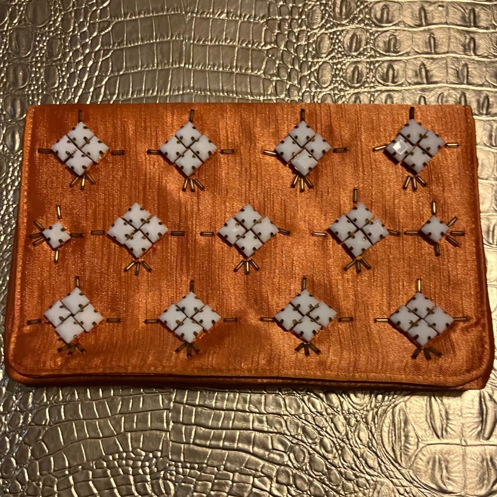 Pretty orange cross body purse.